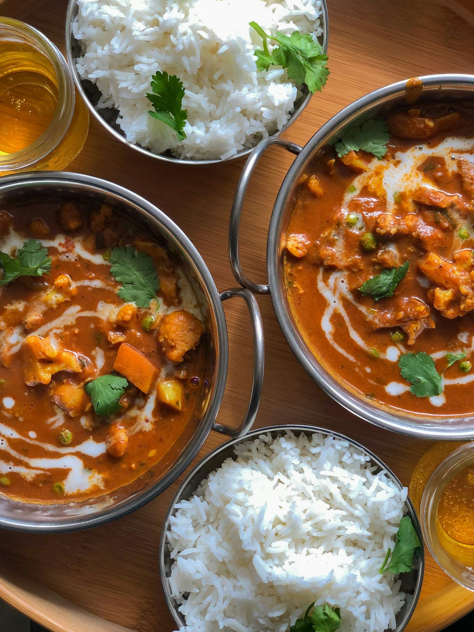 Vegetable curry with peas and cauliflower in a steel bowl, served with steamed rice in daylight